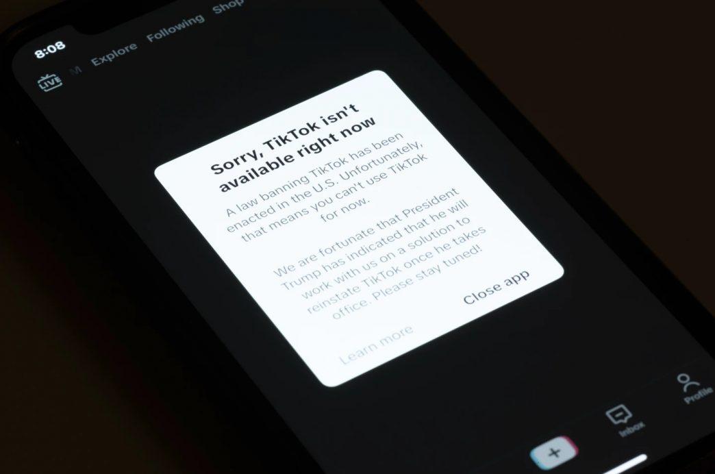 A message reading “Sorry, TikTok isn’t available right now” is displayed from the TikTok app on a cell phone screen on Saturday, Jan. 18, 2025, in Los Angeles. (AP Photo/Andy Bao)