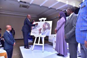 The Minister of ICT and National Guidance, Hon. Dr. Chris Baryomunsi (left) signing on a cardboard of the National BPO Policy as Permanent Secretary for the Ministry of ICT and National Guidance, Dr. Aminah Zawedde, and Prof. William Bazeyo, Chairman of the BPO Council looks on, after the launch of the National Business Process Outsourcing (BPO) Policy and Publicity Campaign at Mestil Hotel. PHOTO: Ministry of ICT