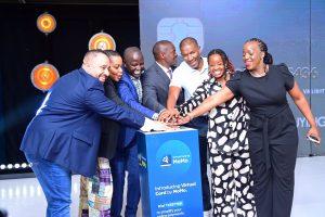 Partners from MTN Mobile Money (U) Limited, MasterCard, Diamond Trust Bank, and Network International press down a button as sign launching the Virtual Card by MoMo. PHOTO: MTN