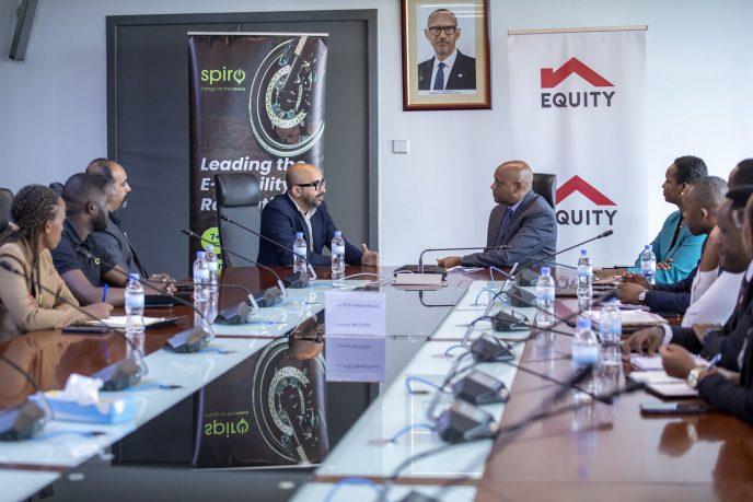Spiro CEO, Kaushik Burman (left) and Equity Bank Rwanda CEO, Hannington Namara (right) discuss their partnership while other representatives look on. PHOTO: Spiro