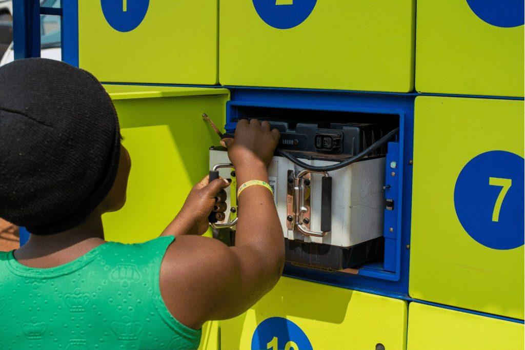 A swap station attendant unmounting a charged battery for swapping. PHOTO: Yongeza