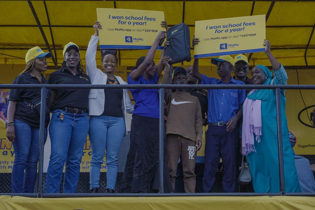 Ruth Nambozo (4th from right) and Zania Nantege (far right) won school fees for a year courtesy of the Win School Fees with MoMo Term 2. COURTESY PHOTO