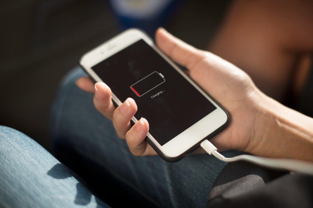 A user pictured charging a phone. PHOTO: rawpixel/Freepik