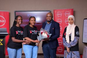 Philip Walera one of the judges of the 2025 Absa GirlCode Hackathon handing over a bouquet of flowers to team Code Forces (from Uganda) having emerged as 2nd runners up in the 2025 Absa GirlCode Hackathon. COURTESY PHOTO