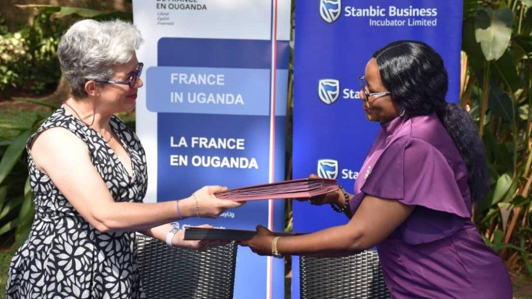 H.E. Mrs Virginie Leroy (left), Ambassador of France to Uganda with Catherine Poran (right), Chief Excecutive Stanbic Business Incubator exchanging contracts shortly after signing. COURTESY PHOTO