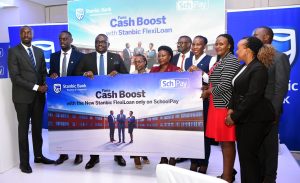 Representatives from Stanbic Bank Uganda and Fincom Technologies pose for a group photo after announcing their partnership to deliver the first fully digital lending solution for schools in the country. COURTESY PHOTO