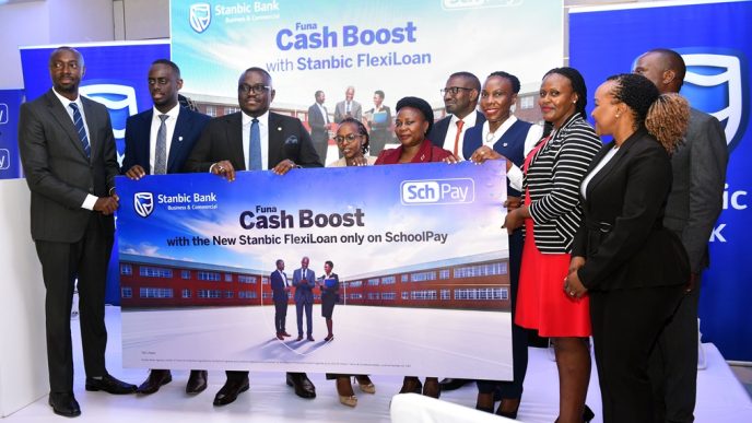 Representatives from Stanbic Bank Uganda and Fincom Technologies pose for a group photo after announcing their partnership to deliver the first fully digital lending solution for schools in the country. COURTESY PHOTO