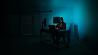 A man at a computer disguised as an anonymous hacker wearing a Guy Fawkes mask. PHOTO: Clint Patterson/Unsplash