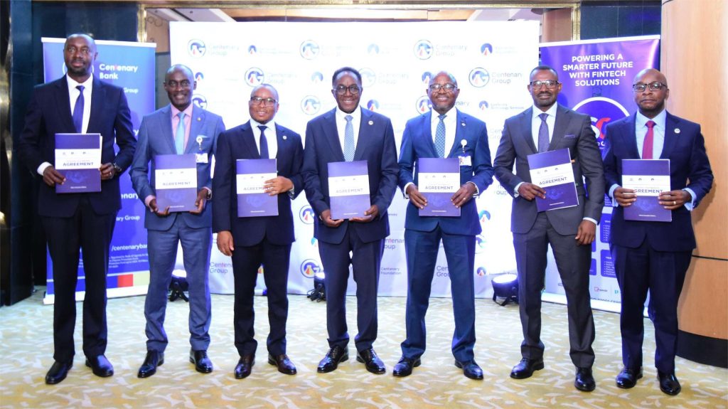 Officials from Centenary Group and Service Cops pose for a group photo after the signing of the Memorandum Of Understanding to accelerate digital financial inclusion in Uganda. COURTESY PHOTO