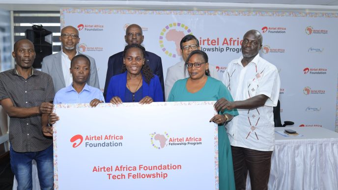 Airtel MD, Soumendra Sahu, (3rd R), Hannington Karuhanga, Board Chair Airtel (in black coat), Patrick Mbonye (in a grey coat), pose with some of the parents of the fellows in Kampala. COURTESY PHOTO