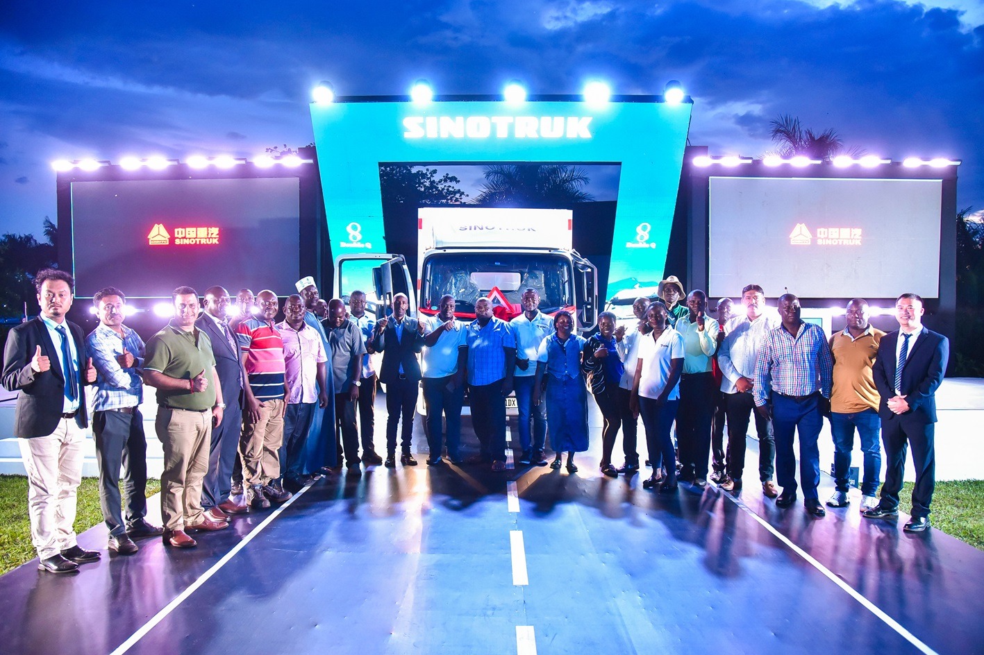 The Resident City Commissioner (3rd from left) for Jinja City, poses with Sinotruk customers and other guests after the unveiling of the Sinotruk 4-tonne. PHOTO: ZedShots