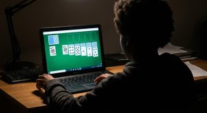 A person playing solitaire on their computer. IMAGE: Created using Gemini