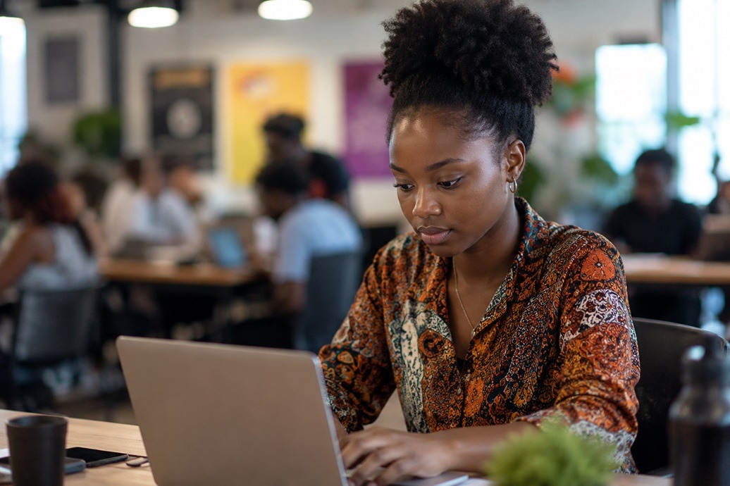 A young woman working on her laptop. IMAGE: AI-Generated