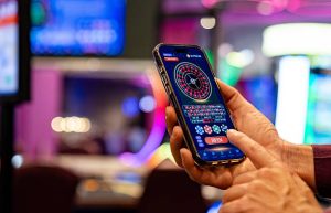 Close-up on a man playing the roulette on a cell phone at a casino - gambling concepts. COURTESY IMAGE