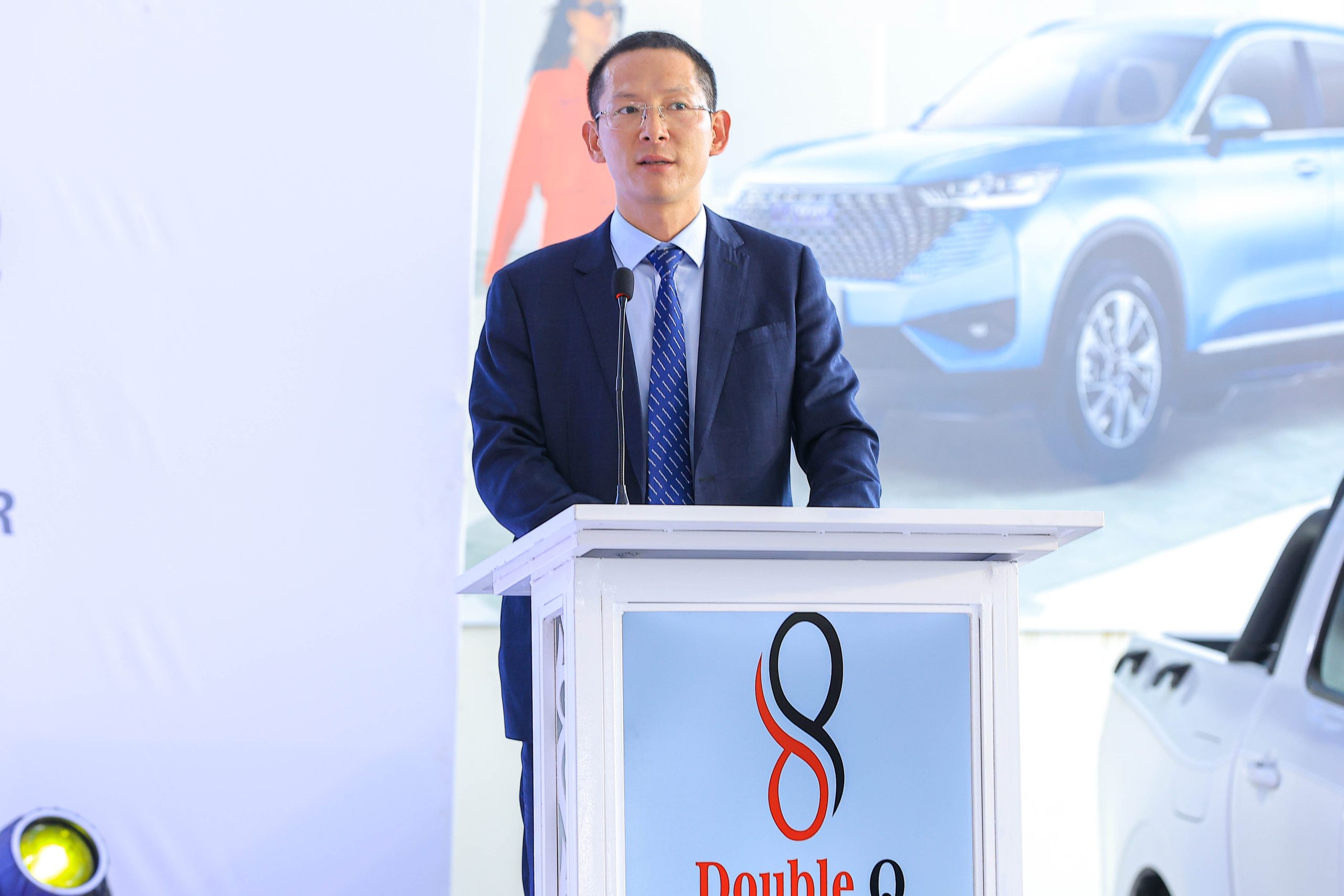 Lin Yu, Managing Director of Double Q Company Limited, speaking during a partnership announcement with DFCU Bank, and ICEA LION General Insurance to make new commercial vehicles more accessible. COURTESY PHOTO