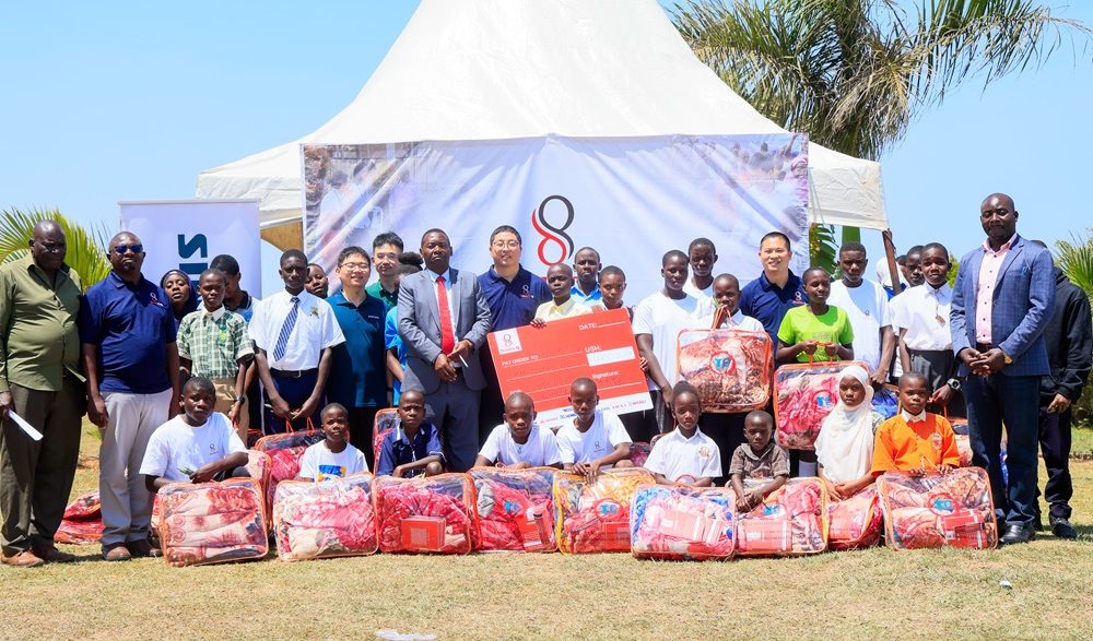 Double Q team poses for a group photo with school students in Kalungu District. COURTESY PHOTO