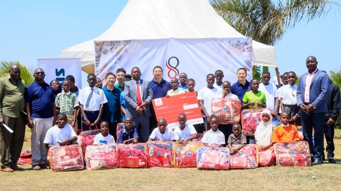 Double Q team poses for a group photo with school students in Kalungu District. COURTESY PHOTO